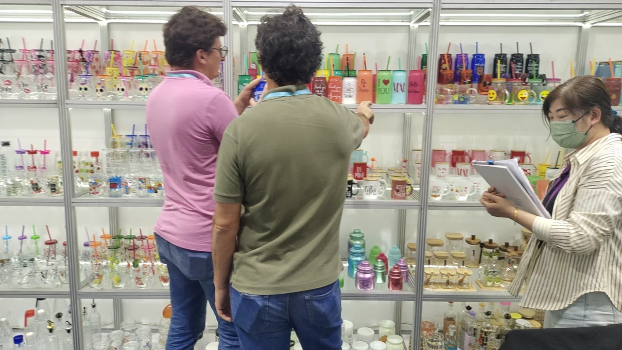 Visitors discussing glassware at the Glassboy booth